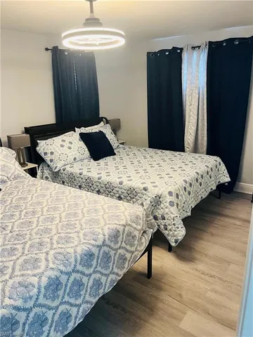 a bedroom with bed and wooden floor