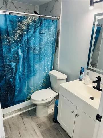 a white toilet sitting next to a bathroom sink
