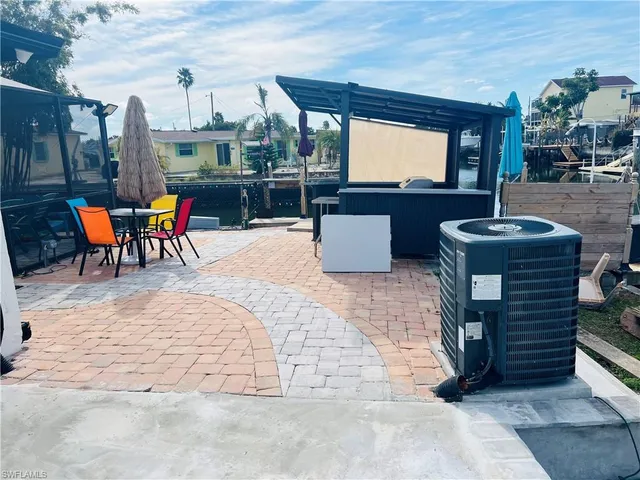 a living room with furniture a fireplace and a large window