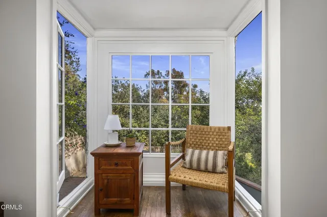 a view of a room with furniture wooden floor and windows
