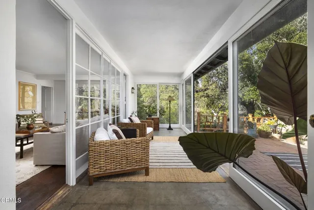 a living room with furniture city view and large windows