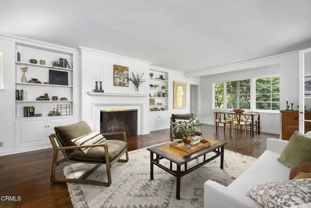 a living room with furniture a fireplace and a large window