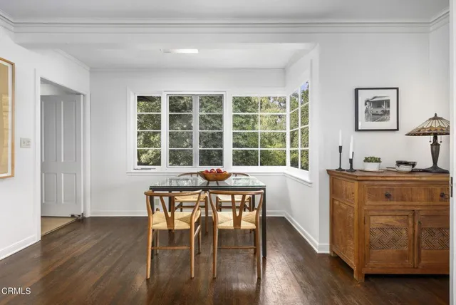 a dining room with wooden floor and a window