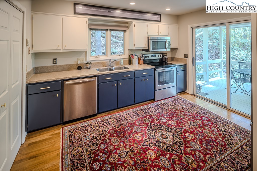 250 Fir, Unit A1 Boone, NC 28607 - Photo 11 of 31 a kitchen with stainless steel appliances granite countertop a sink stove and refrigerator
