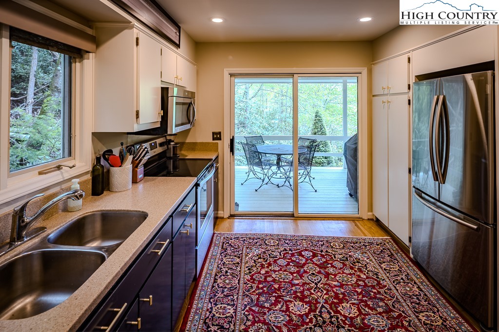 250 Fir, Unit A1 Boone, NC 28607 - Photo 12 of 31 a kitchen with stainless steel appliances granite countertop a refrigerator a sink and a stove