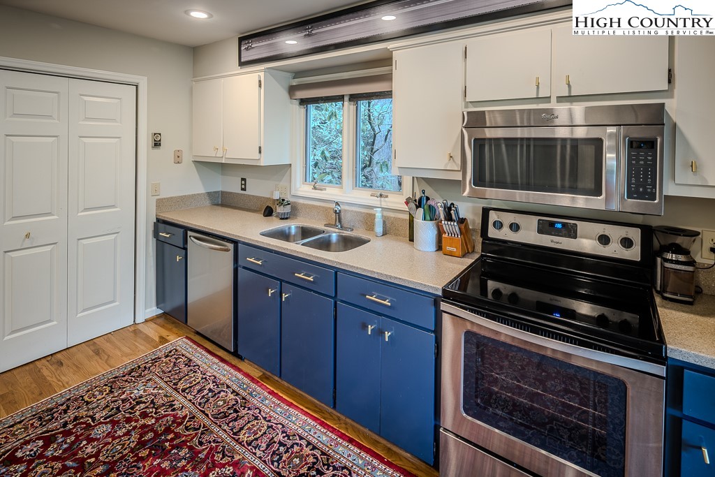 250 Fir, Unit A1 Boone, NC 28607 - Photo 13 of 31 a kitchen with a stove and a microwave