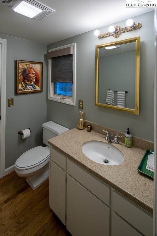 250 Fir, Unit A1 Boone, NC 28607 - Photo 15 of 31 a bathroom with a granite countertop toilet sink and mirror
