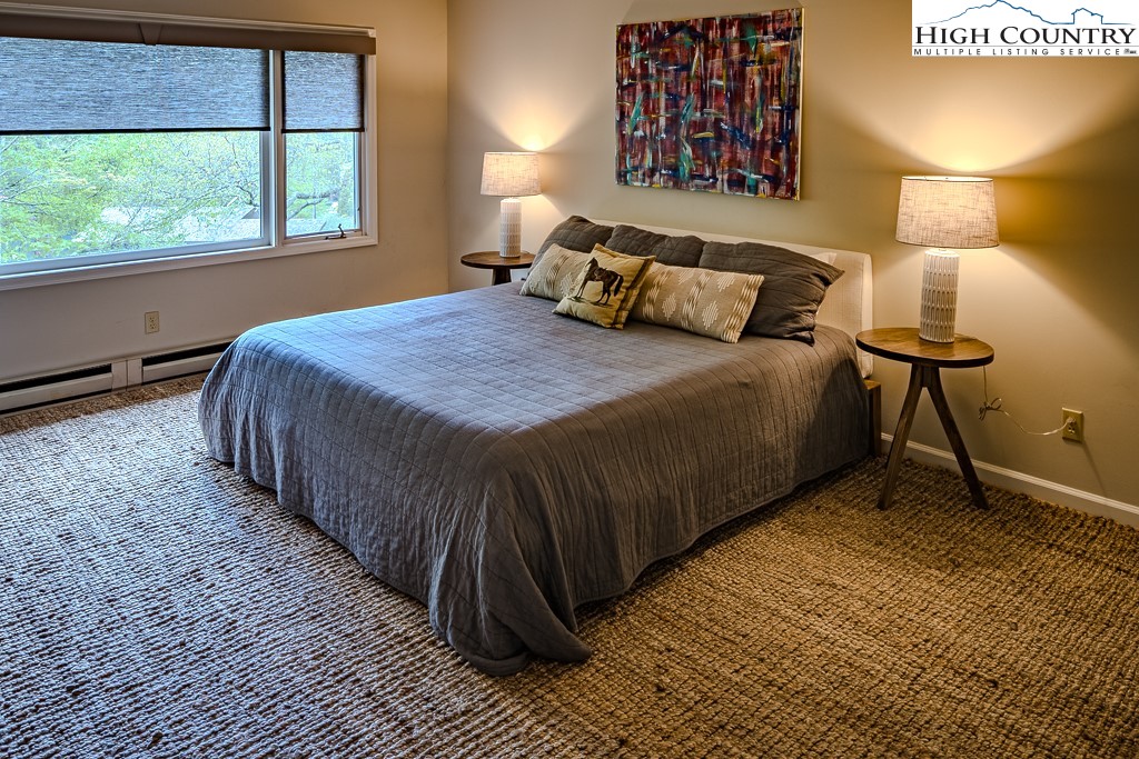 250 Fir, Unit A1 Boone, NC 28607 - Photo 16 of 31 a bedroom with a bed and a night stand