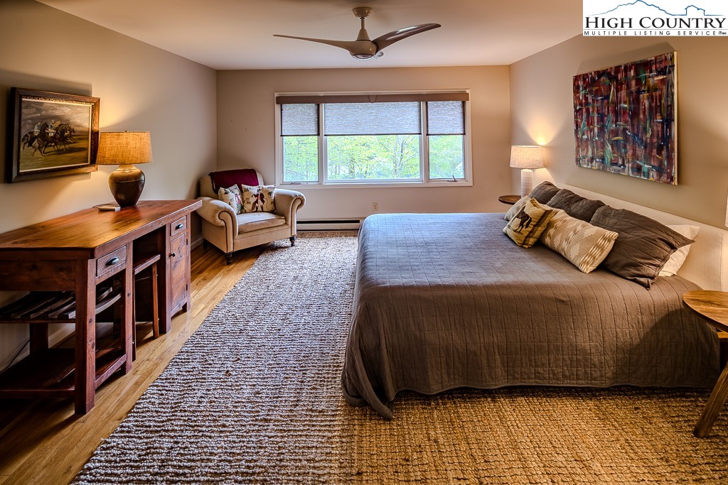 250 Fir, Unit A1 Boone, NC 28607 - Photo 17 of 31 a bedroom with a bed and a window