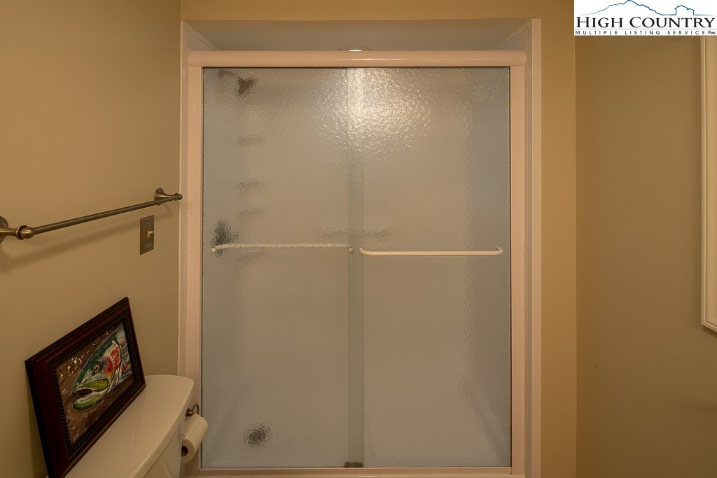 250 Fir, Unit A1 Boone, NC 28607 - Photo 20 of 31 a bathroom with a shower and a mirror