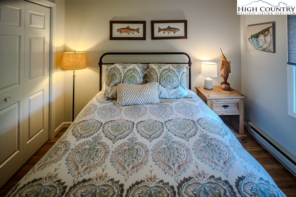 250 Fir, Unit A1 Boone, NC 28607 - Photo 22 of 31 a bedroom with a bed and painting on the wall