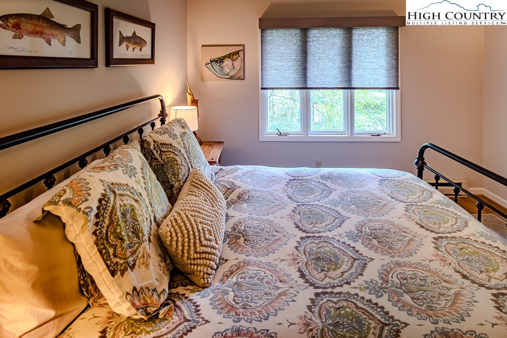 250 Fir, Unit A1 Boone, NC 28607 - Photo 23 of 31 a bedroom with a bed and a window