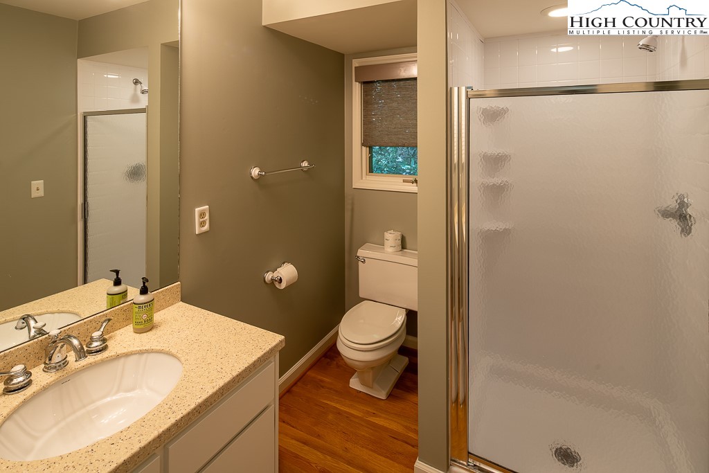 250 Fir, Unit A1 Boone, NC 28607 - Photo 24 of 31 a bathroom with a granite countertop sink toilet and shower