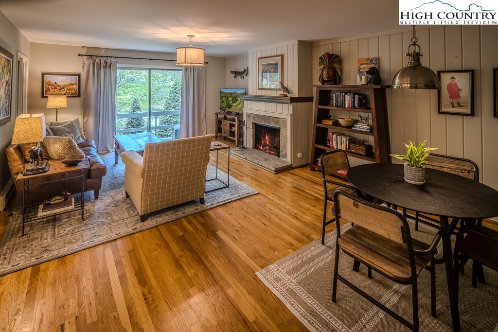 250 Fir, Unit A1 Boone, NC 28607 - Photo 3 of 31 a living room with furniture a fireplace and a large window