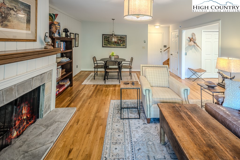 250 Fir, Unit A1 Boone, NC 28607 - Photo 6 of 31 a living room with furniture a fireplace and a flat screen tv