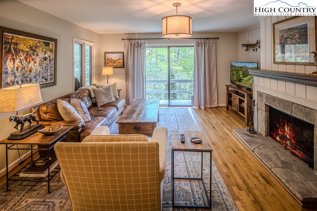 250 Fir, Unit A1 Boone, NC 28607 - Photo 8 of 31 a living room with furniture fireplace and flat screen tv