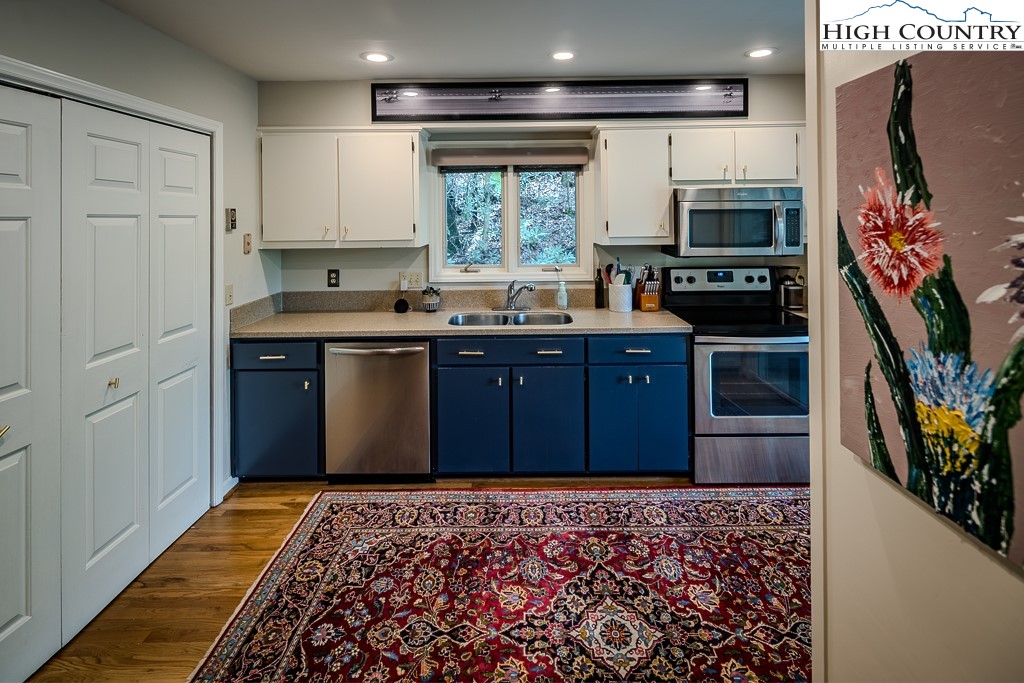 250 Fir, Unit A1 Boone, NC 28607 - Photo 10 of 31 a kitchen with stainless steel appliances granite countertop a stove and a refrigerator