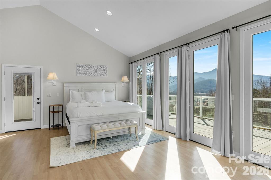 56 Great Horned Owl Road Candler, NC 28715 - Photo 15 of 32 a bedroom with a bed and a large window