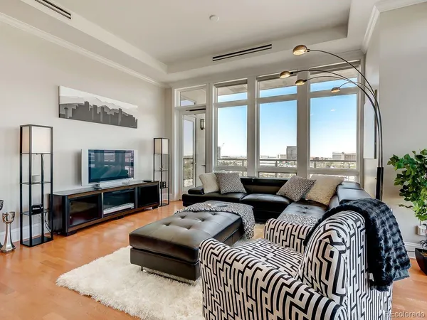 a bedroom with furniture and a flat screen tv