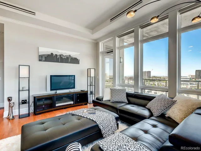 a bedroom with furniture and a flat screen tv