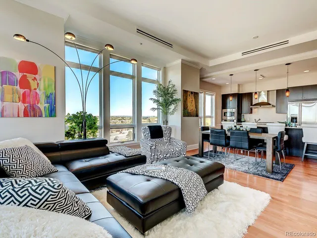 a living room with furniture fireplace and large window