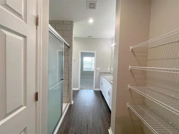 a view of hallway with wooden floor