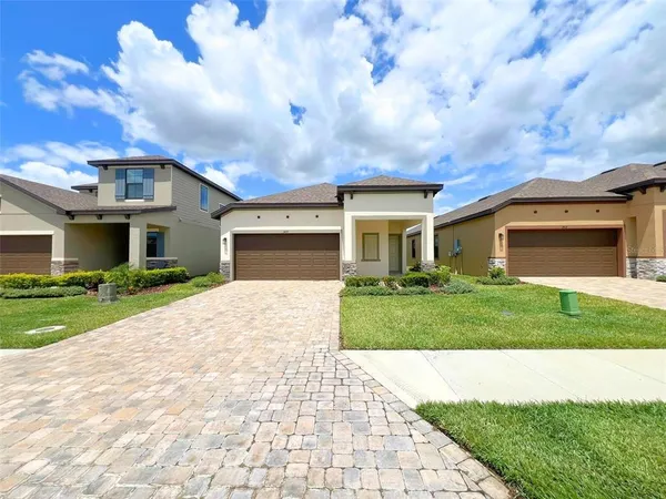 a front view of a house with a yard and garage