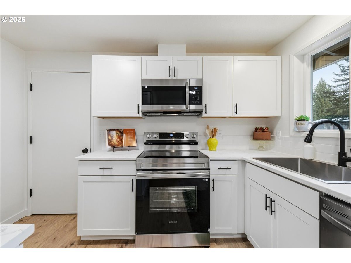 27910 Northeast 28th Street Camas, WA 98607 - Photo 11 of 25 a kitchen with cabinets stainless steel appliances and a sink