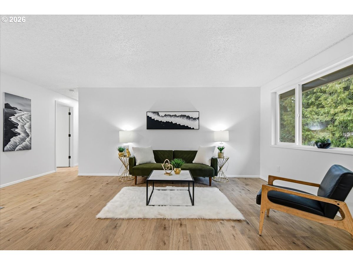 27910 Northeast 28th Street Camas, WA 98607 - Photo 6 of 25 a living room with furniture and a wooden floor