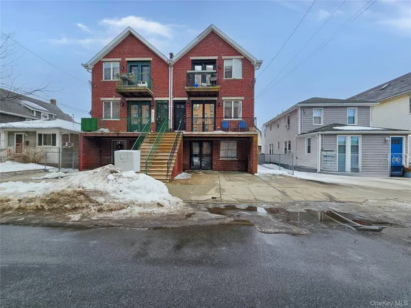 a front view of a residential apartment building with a yard
