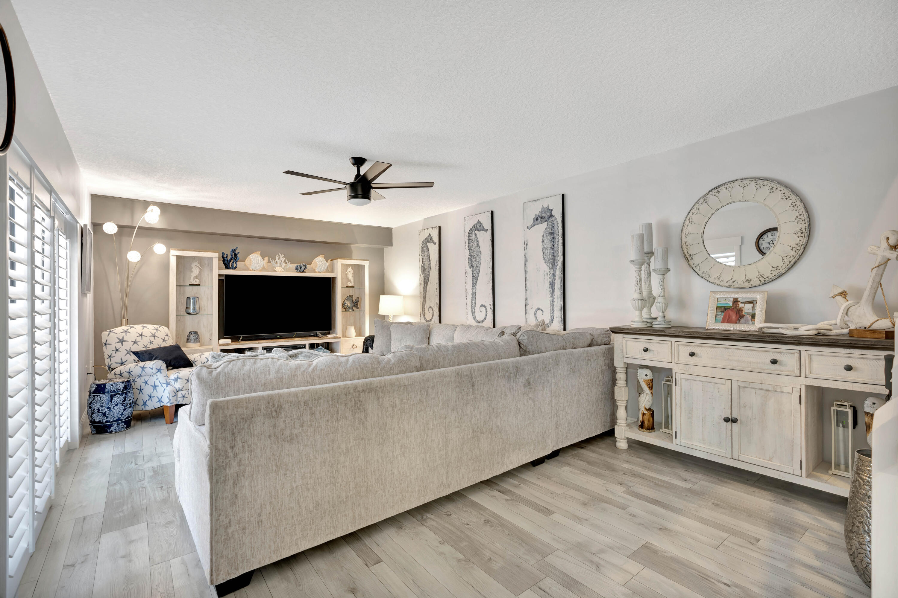 1209 12th Court Jupiter, FL 33477 - Photo 8 of 31 a living room with furniture and a flat screen tv