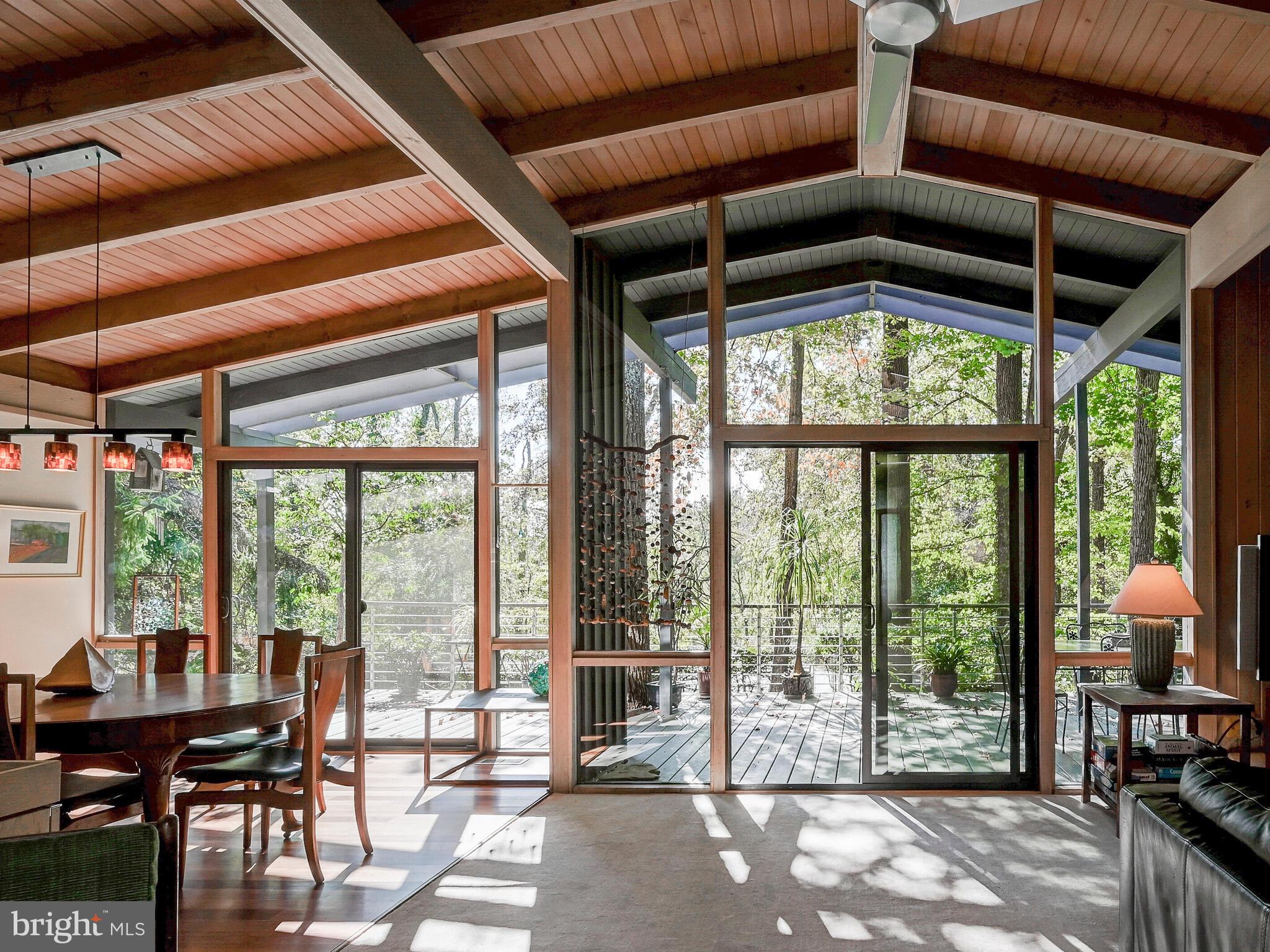 a view of a livingroom with furniture and floor to ceiling window