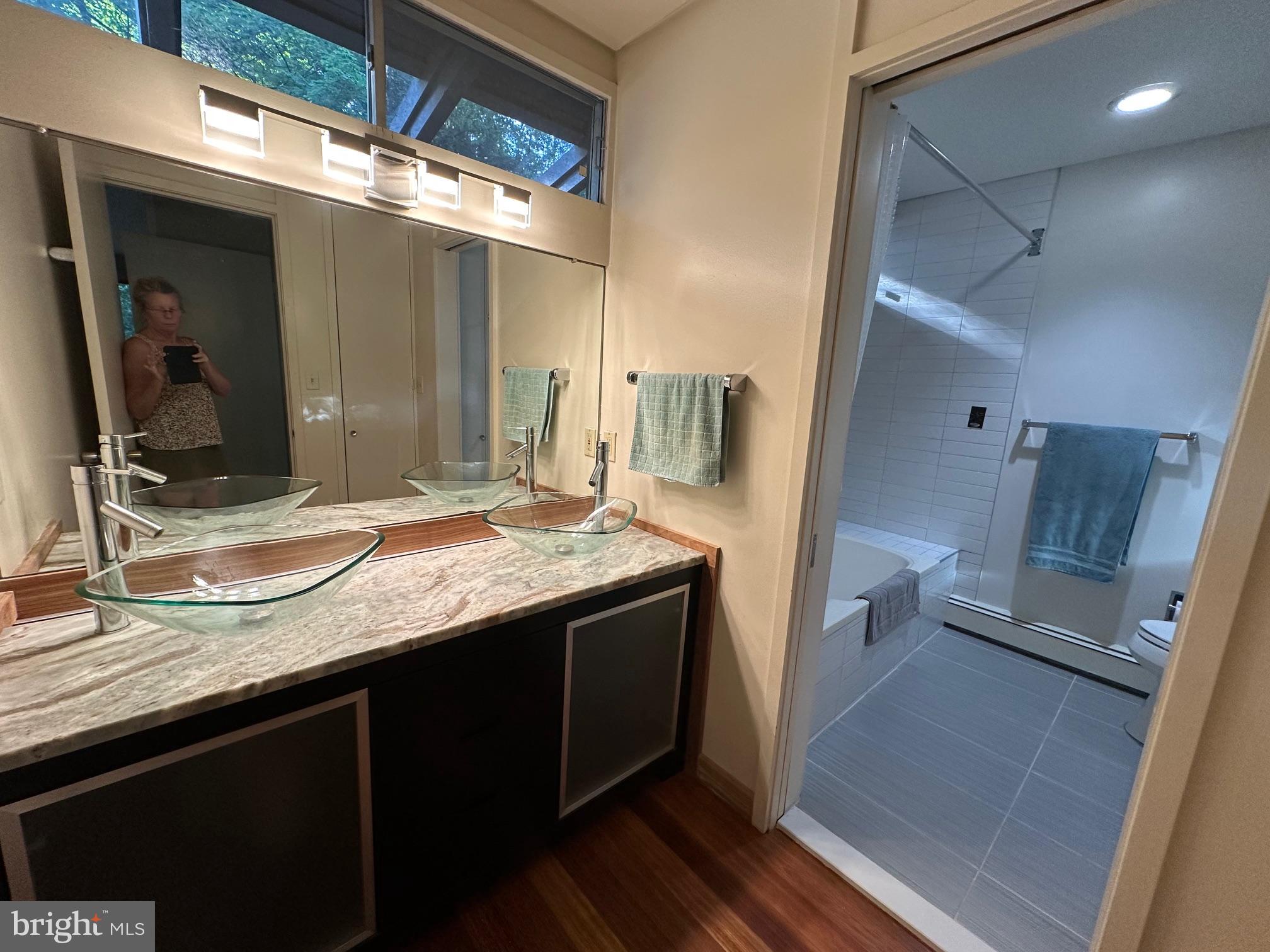 6016 The Terraces Baltimore, MD 21209 - Photo 25 of 59 a bathroom with a granite countertop sink and a mirror