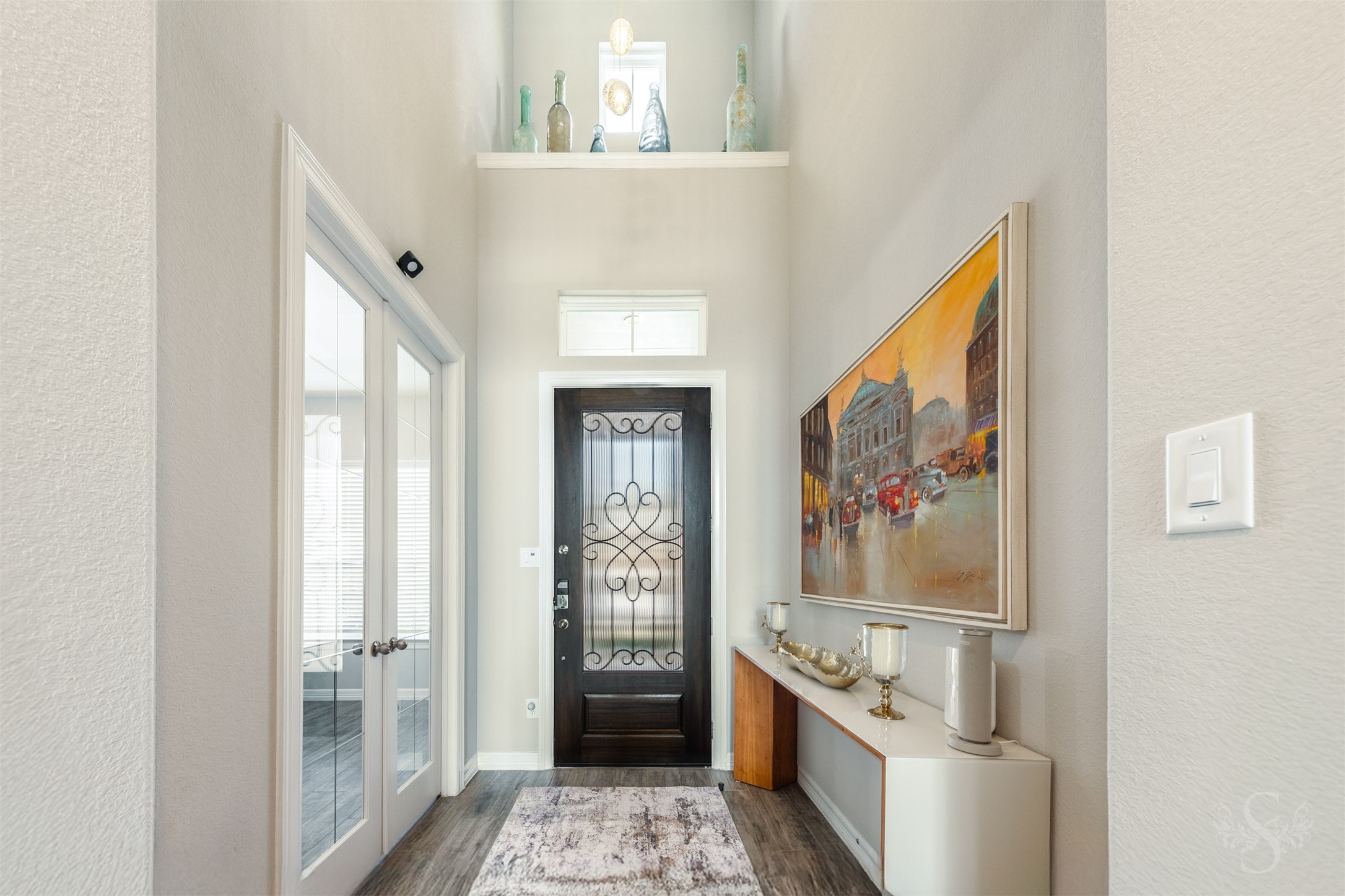 24123 Corinaldo Court Katy, TX 77493 - Photo 7 of 50 a hallway with painting on the wall and a window