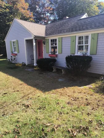 a front view of a house with a yard