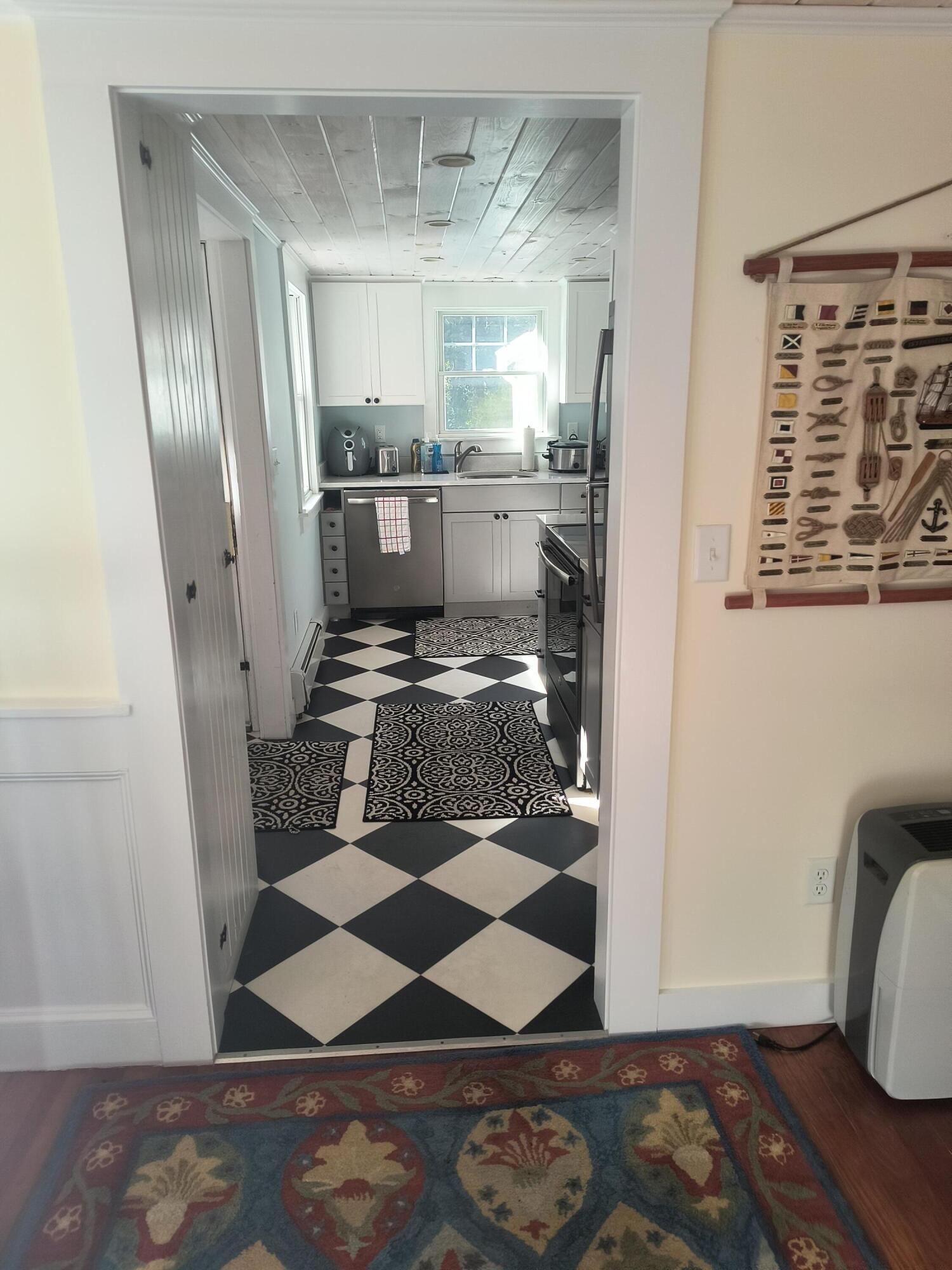 1413 Falmouth Road Centerville, MA 02632 - Photo 16 of 28 a kitchen with a refrigerator and wooden floor
