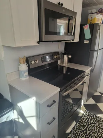 a kitchen with a stove and a microwave