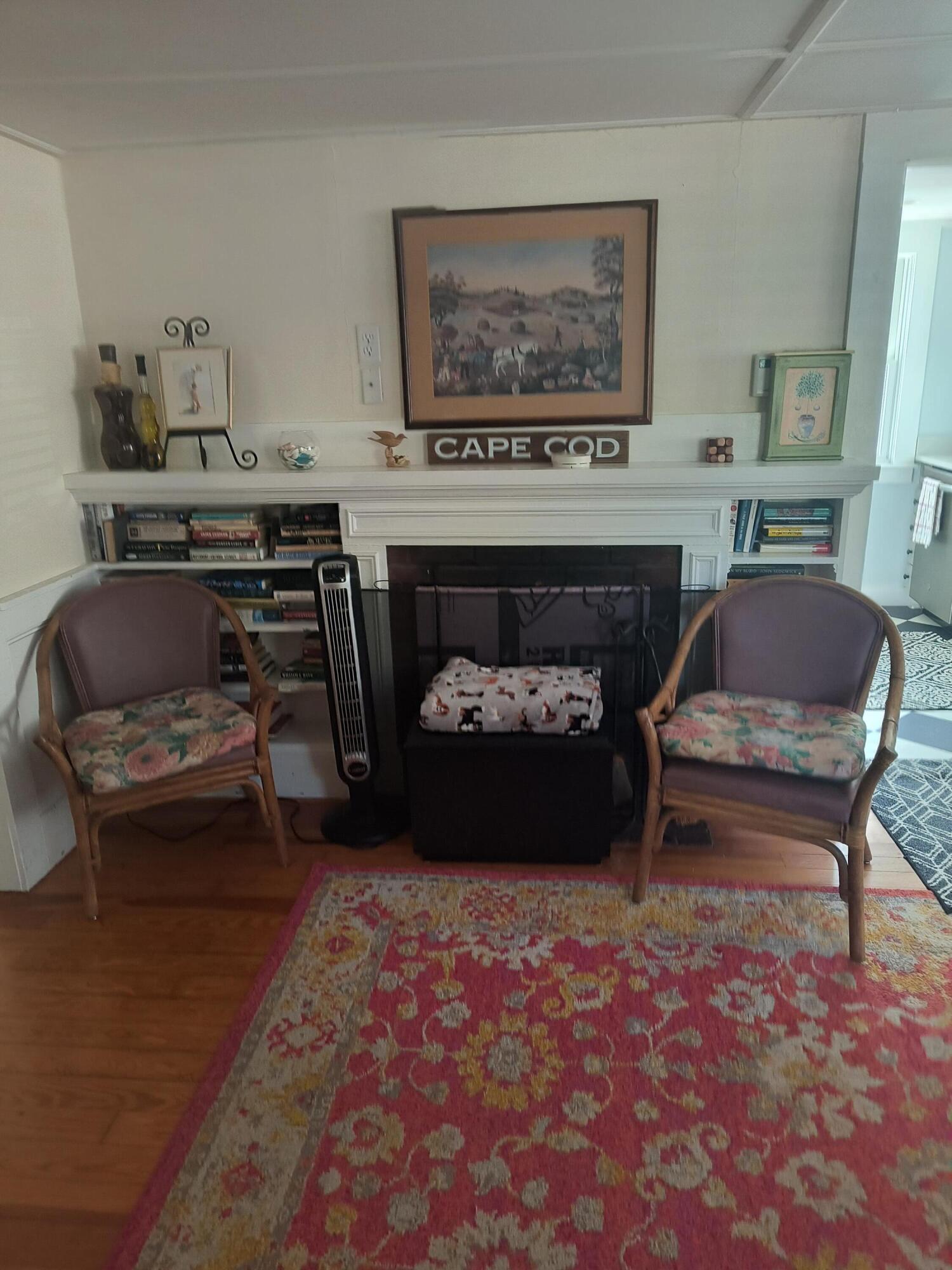 1413 Falmouth Road Centerville, MA 02632 - Photo 2 of 28 a living room with furniture and a fireplace