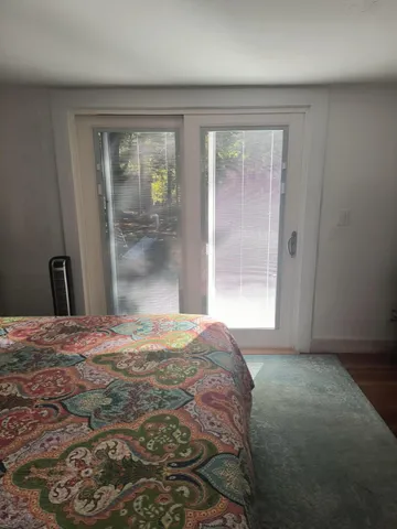 a bedroom with a bed and large window