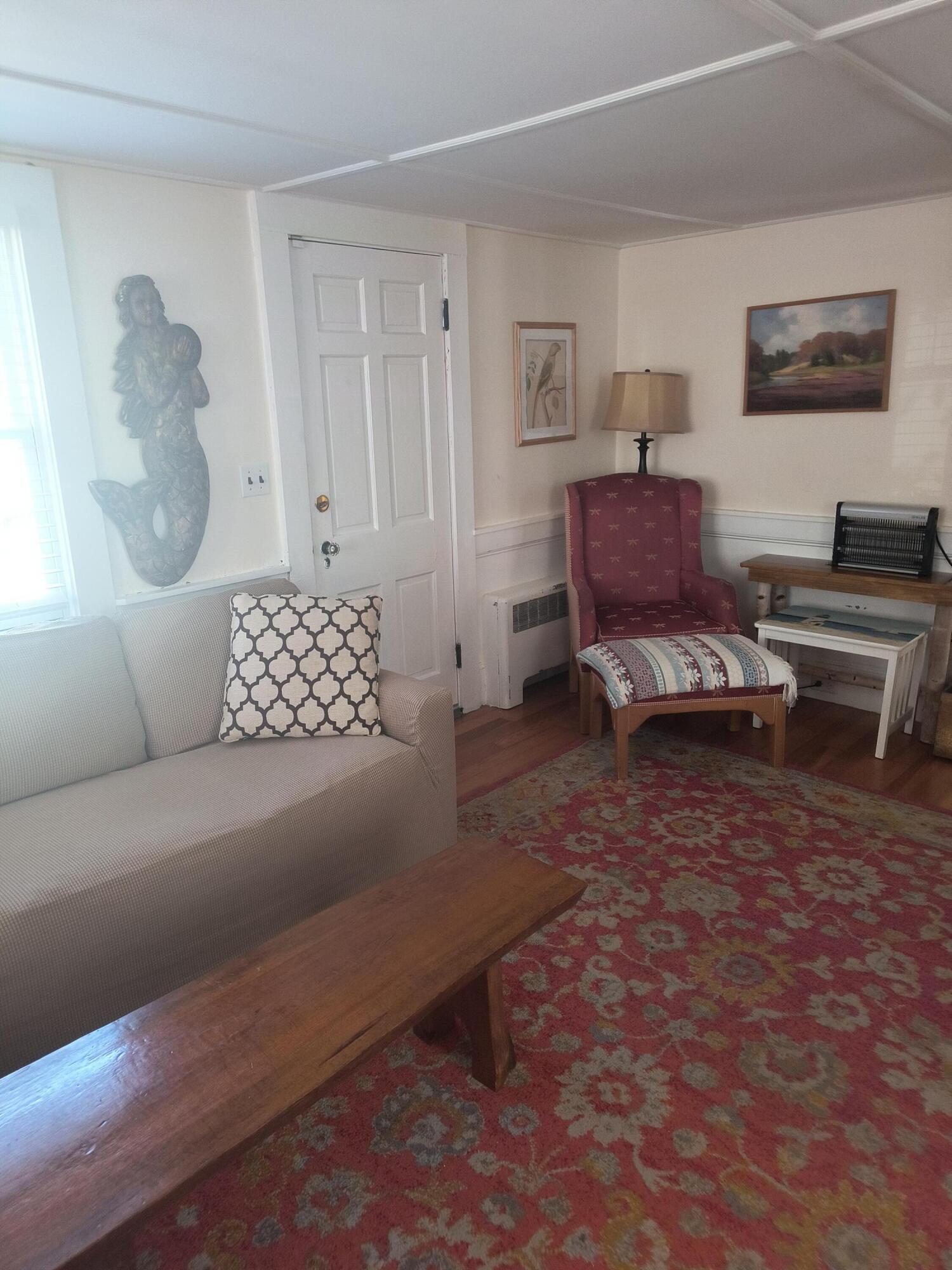 1413 Falmouth Road Centerville, MA 02632 - Photo 6 of 28 a living room with furniture and a night stand