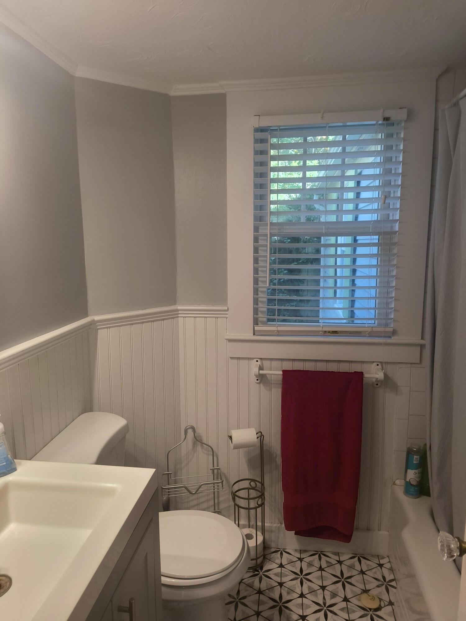 1413 Falmouth Road Centerville, MA 02632 - Photo 9 of 28 a bathroom with a toilet a sink and a window