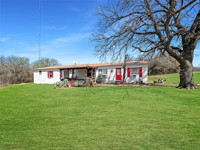 a view of an house with backyard space and garden