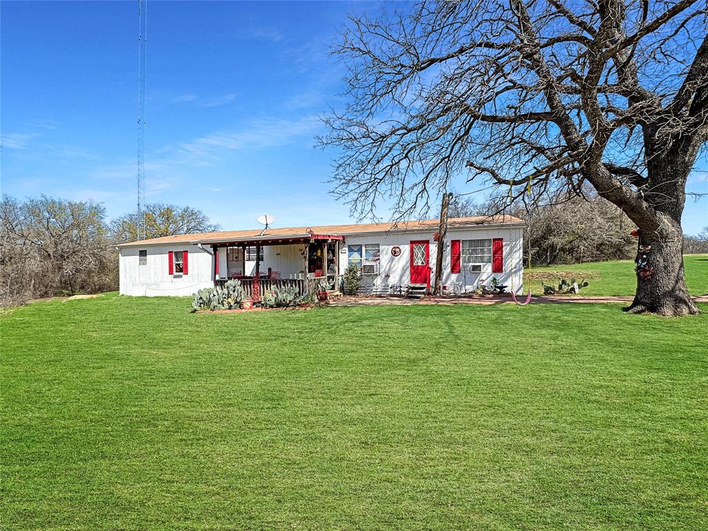 1791 County Road 3855 Poolville, TX 76487 - Photo 1 of 31 a view of an house with backyard space and garden