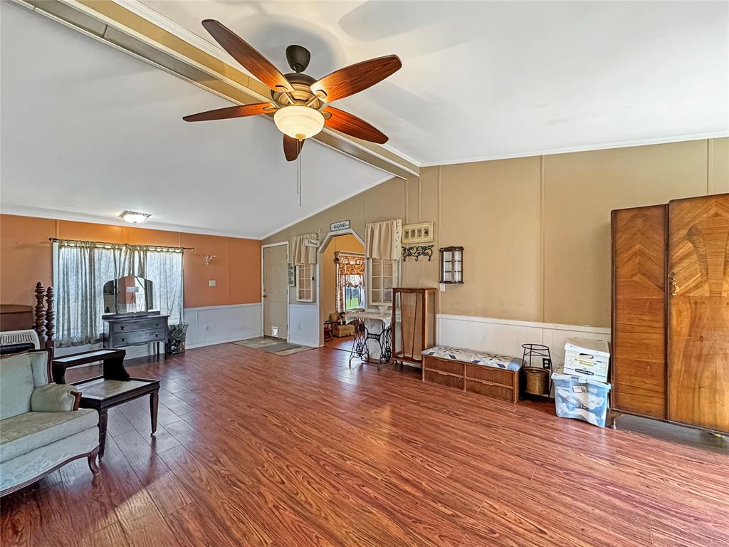 1791 County Road 3855 Poolville, TX 76487 - Photo 13 of 31 a living room with furniture and a wooden floor
