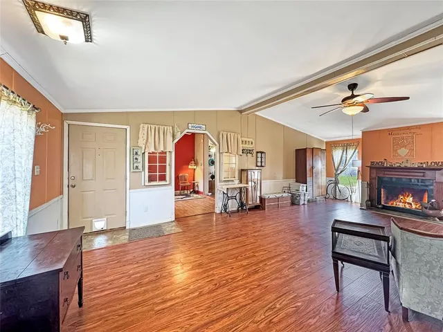 a living room with fireplace furniture and a wooden floor