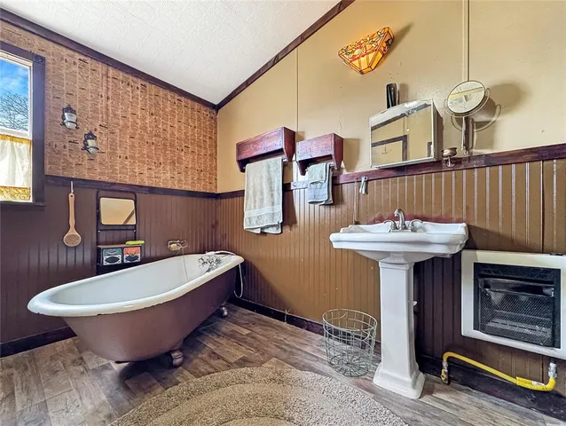 a bathroom with a bathtub sink and mirror