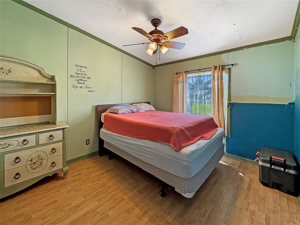 1791 County Road 3855 Poolville, TX 76487 - Photo 20 of 31 a bedroom with a bed and a tv in it