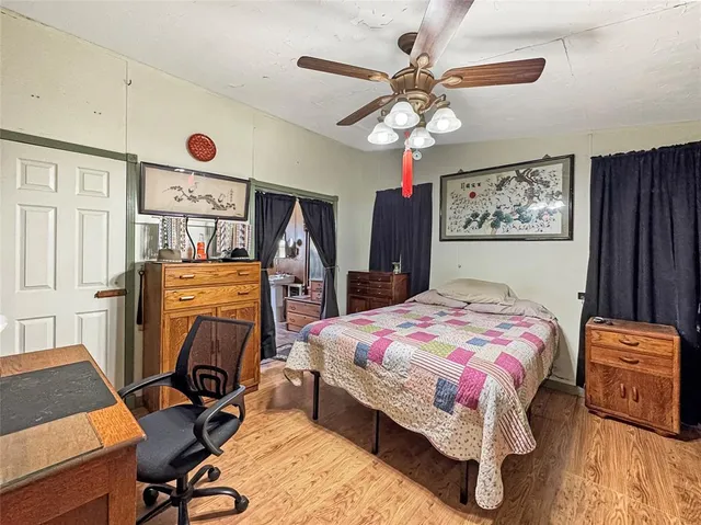 a bedroom with a bed and a chandelier