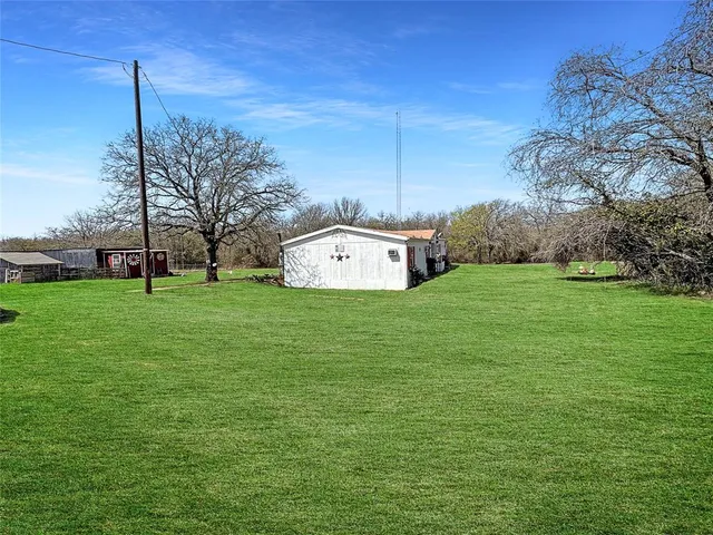 a view of a big yard with a house