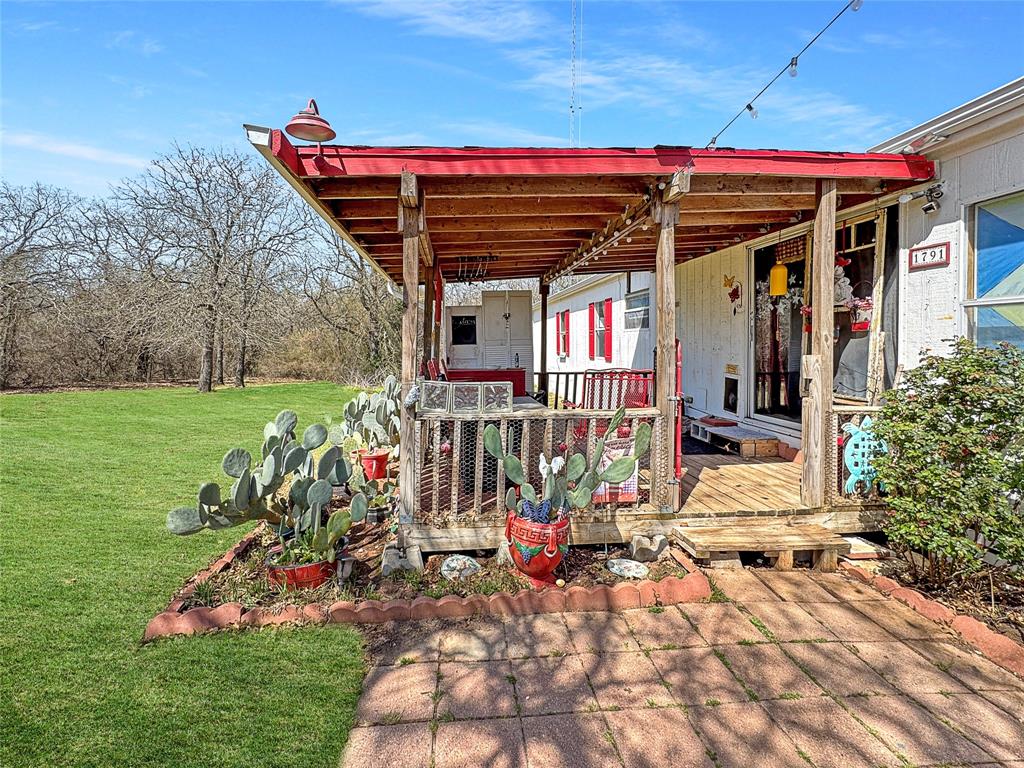 1791 County Road 3855 Poolville, TX 76487 - Photo 5 of 31 a view of a chairs and table in backyard of the house
